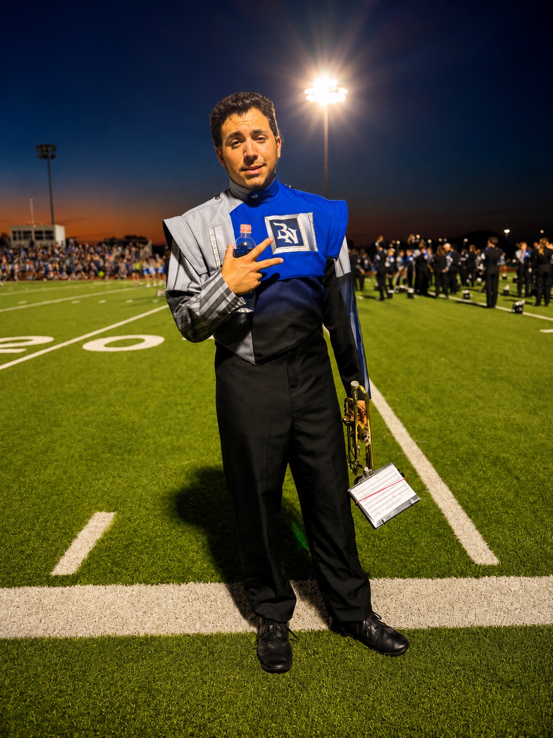 Marching band performer under stadium lights